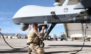 Cpl. John Watt, avionics specialist, 42d Attack Squadron, Royal Air Force, Creech Air Force Base, Nev., challenges a mode 4, Identify Friend or Foe (IFF) cryptic code on the MQ-9 Reaper prior to flight. Cpl. Watt is part of the 432d Aircraft Maintenance Squadron (AMXS), members included United States Air Force, Royal Air Force and Nevada Air National Guard maintainers, making it a very unique Combined/Total force operation. USAF Photo by Lawrence Crespo Released
